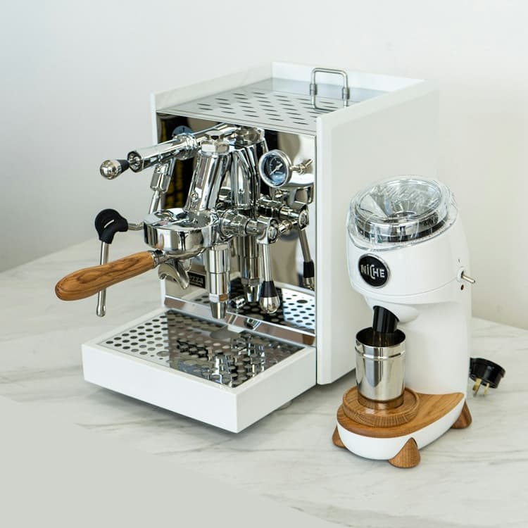 A coffee machine sitting on a clean white counter, ready for use
